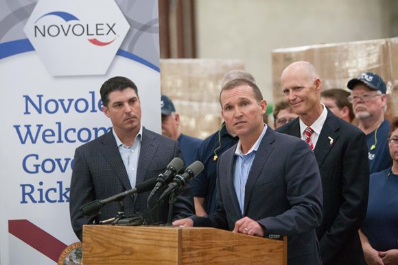Mayor Curry speaking at the Novolex expansion earlier this year, with Gov. Rick Scott standing behind him.