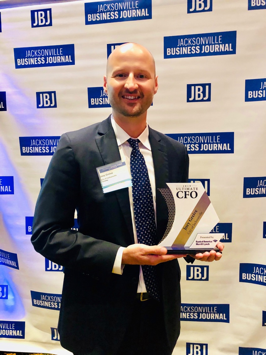 Patrick Greive holding Jacksonville Business Journal CFO of the Year Award