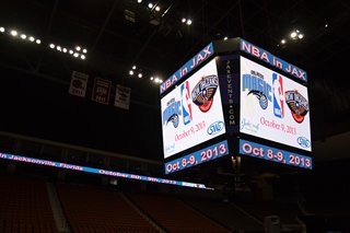 A shot of the hanging scoreboard in the Veterans Memorial Arena showing the team league logos with the game's date of October 9.