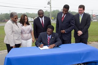 Mayor Brown signs Renew Jax ordinance surrounded by Council Members and nonprofit leaders
