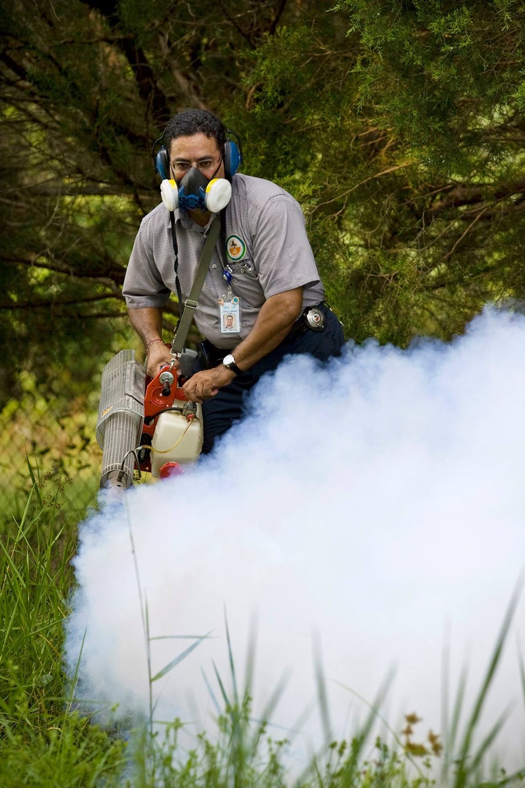 mosquito control employee ground fogging ditch