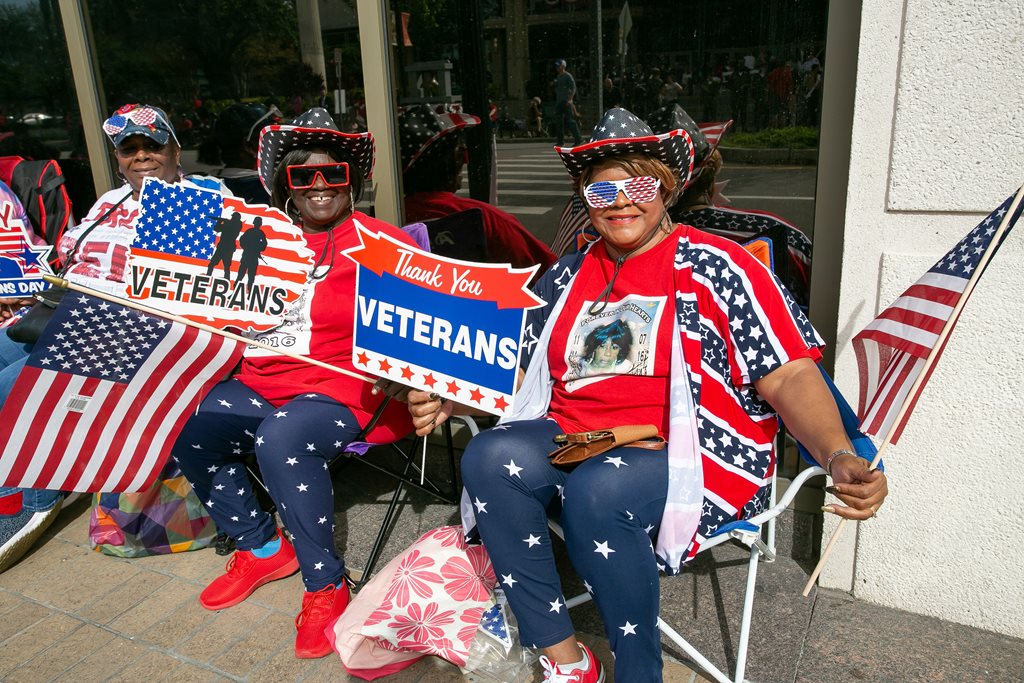 patriotic women watching veterans day parade