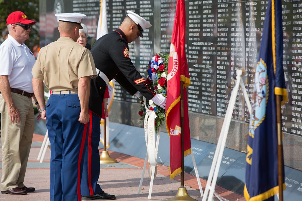 Marines lay a memorial wreath during the 2016 Memorial Day Observance at the Jacksonville Veterans Memorial Wall.