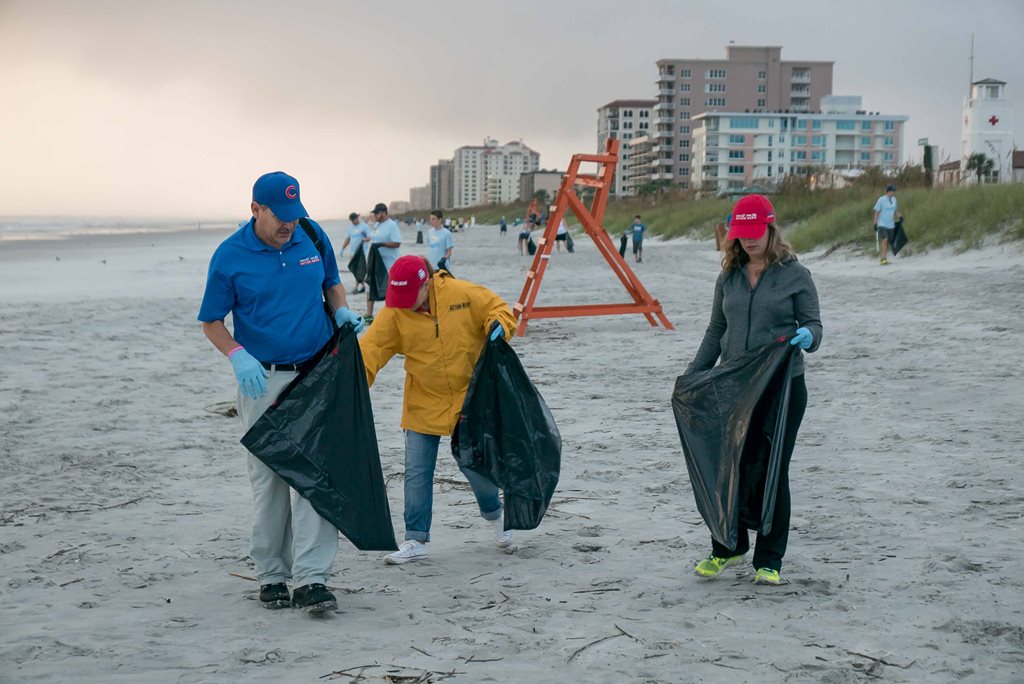 Volunteers picking up trash on beach
