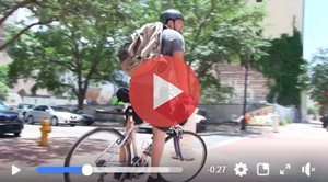 video screengrab of man riding bike to work