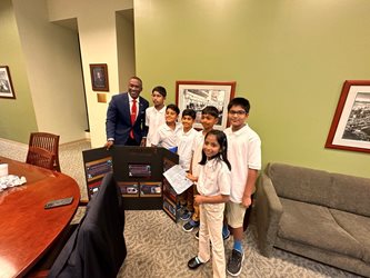 Photo of Council President Terrance Freeman with the Shiva Robotic Academy Robotics Team