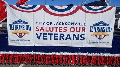 Banner on the City of Jacksonville's float at the 2019 Veterans Day Parade that reads 