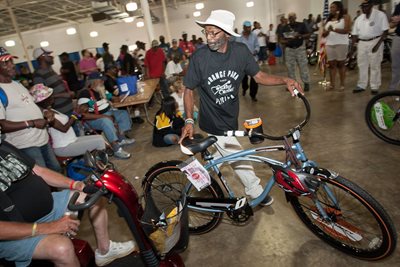 Man receiving a bike at a previous Homeless Veteran Stand Down event. 