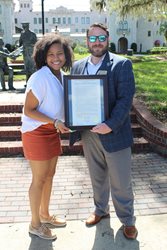 Photo of Council Member Carrico Presenting a resolution to Bolles Student Taylor Richardson