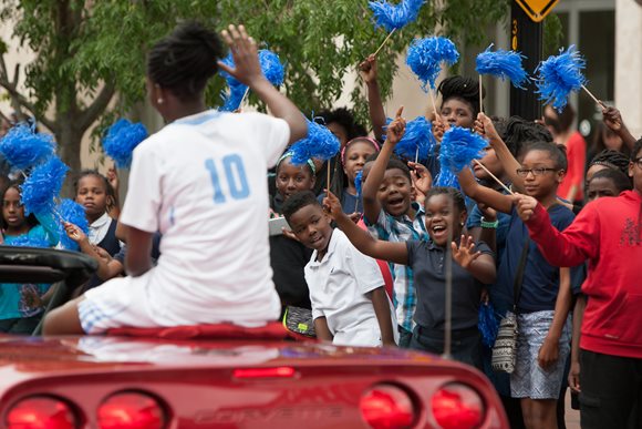 Onlookers cheer on the players of the national champion Ribault Lady Trojans during the April 12, 2016 parade