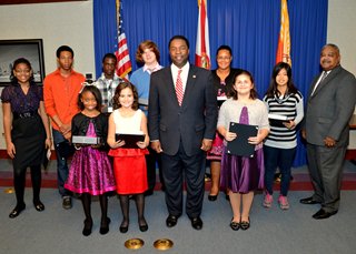 Mayor Alvin Brown with the winners of the essay contest