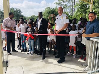 June 21, 2019 photo of Director Daryl Jospeh, Council Member Terrance Freeman, Chief Keith Powers, and Chief Keith Meyerl at the ribbon cutting for the Lonnie Miller Park Amphitheatre.