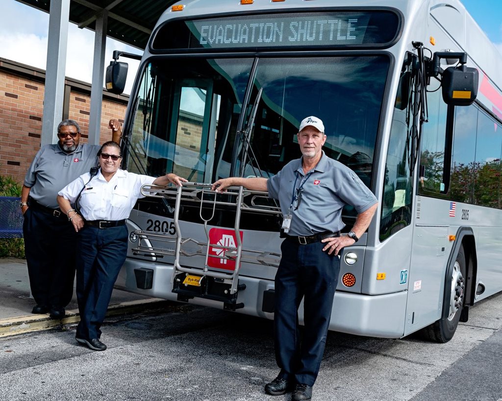 JTA Evacuation shuttle bus with drivers posing in front
