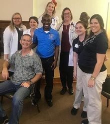 August 4, 2018 photo of Council Member Garrett Dennis with the Saint Vincent/University of North Florida Team at the Free Back to School Health Fair