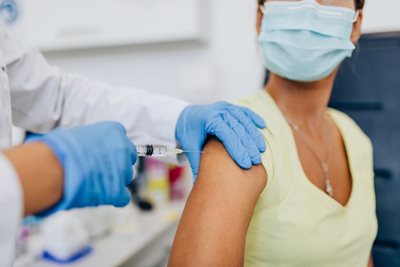 woman getting vaccine from a doctor