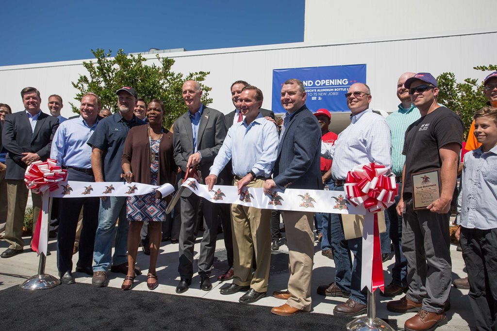 Governor Scott and City officials cutting the ribbon at the Metal Container Corporation earlier this year. 