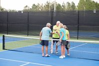 Seniors shaking hands after pickleball match