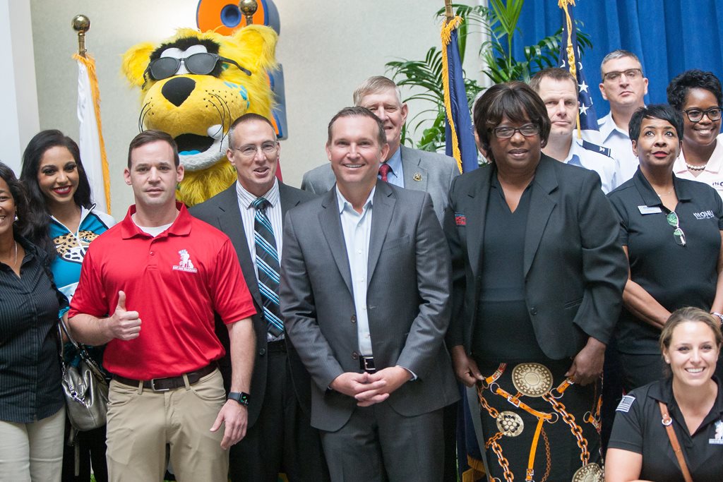 Mayor in a group photo with grant recipients and Jaguars organization representatives. 