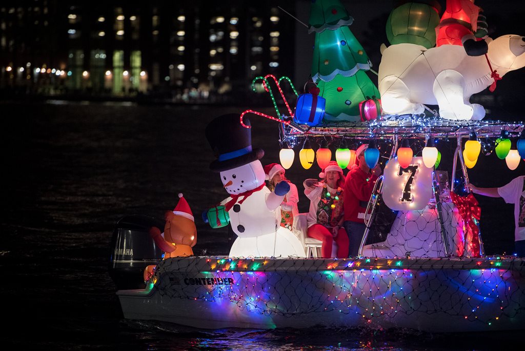 boat adorned with christmas lights and inflatable decorations