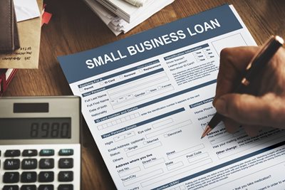 person filling out small business loan application