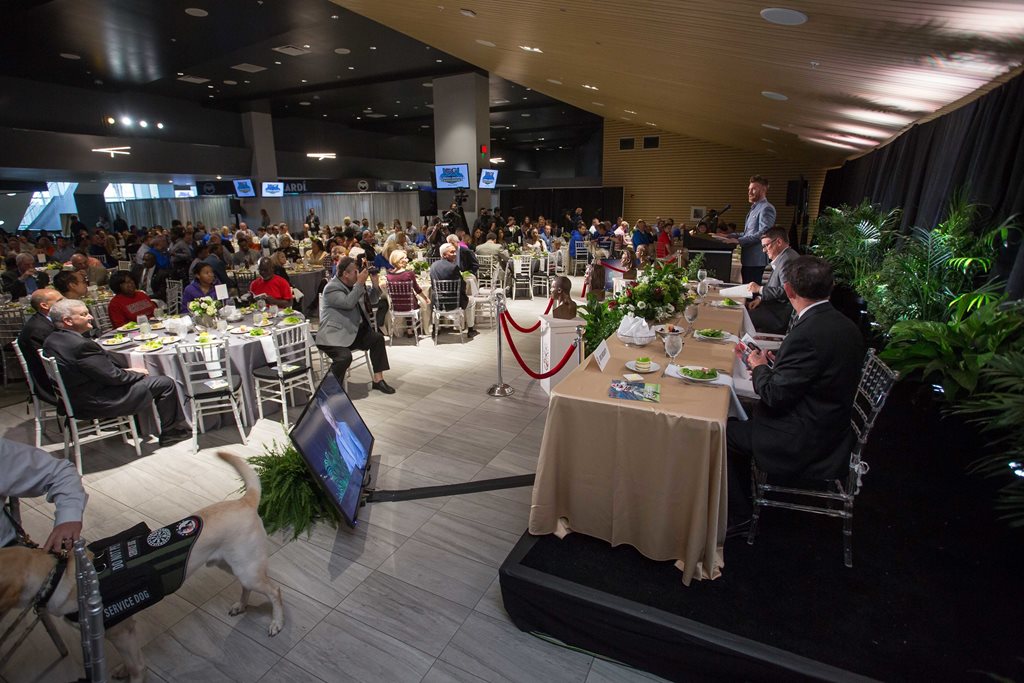 People sitting at round banquet tables at luncheon