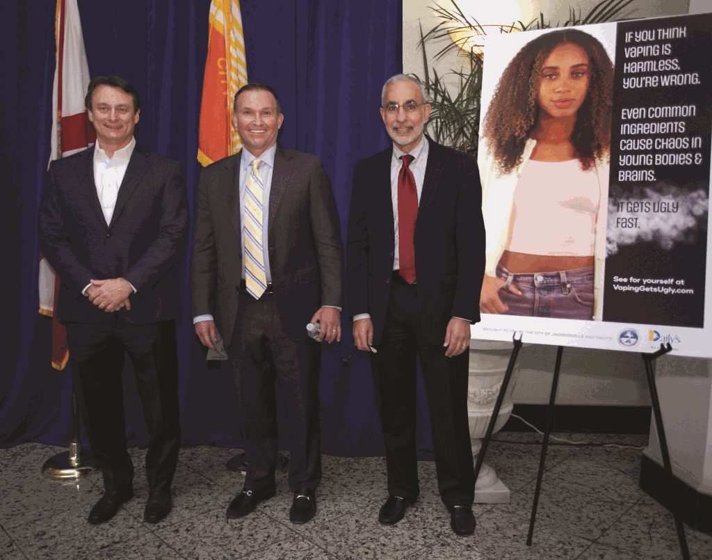 Aubrey Edge, Mayor Lenny Curry and CM Ron Salem in from of a blue backdrop and vaping psa campaign poster