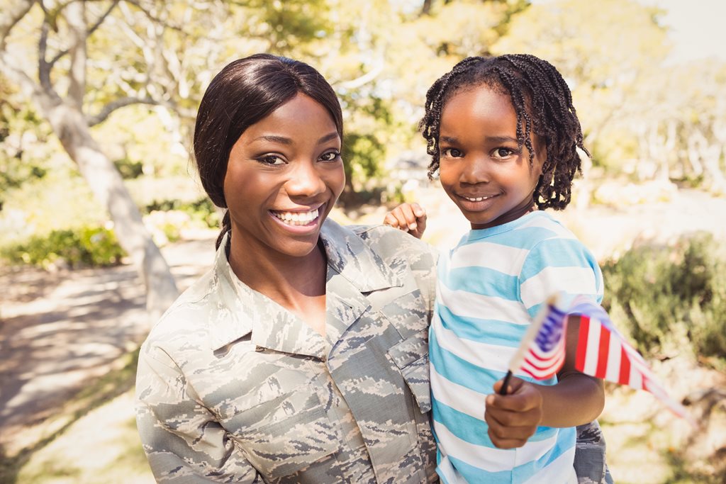 Female solider holding small child