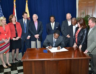 Mayor Brown signing his $11 million reinvestment plan into law