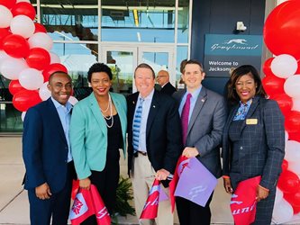 April 12, 2018 photo of Council Members Garrett Dennis and Jim Love and Florida House Representatives Tracie Davis and Jason Fischer at Intercity Bus Terminal ribbon cutting event.
