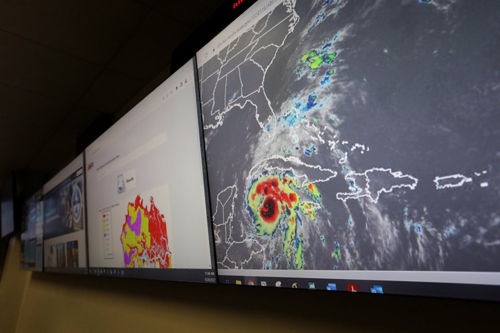 tv screen showing hurricane weather maps