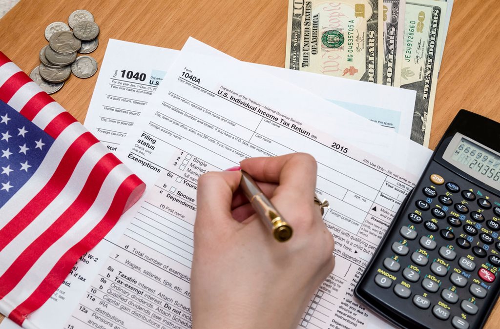 Tax forms with american flag and calculator