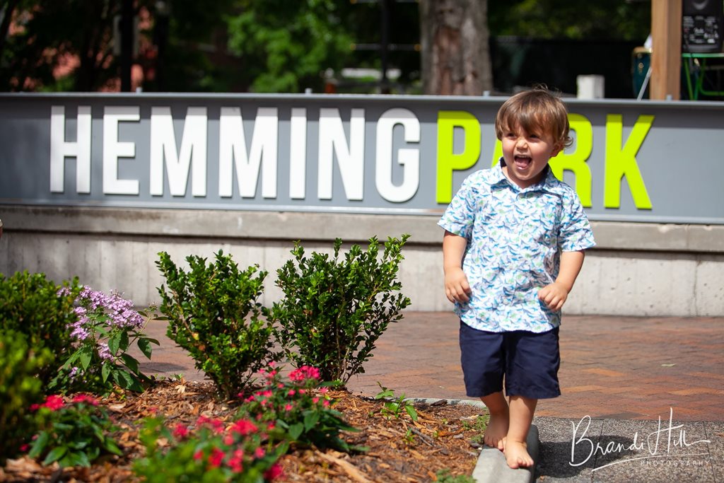 laughing boy in front of hemming park sign - brandi hill photography