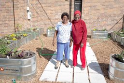 Seniors stand in community garden