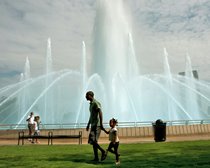 Father and daughter enjoy walk around historic Friendship Fountain