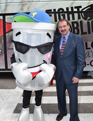 Photo of Council Member John Crescimbeni with the Fight the Blight Mascot.