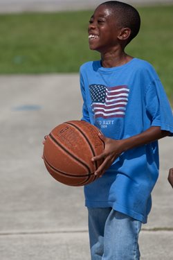 small boy holding basketball