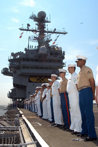 Sailors and Marines standing at attention on the deck of a ship at Naval Station Mayport