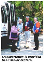 Photo of program participants boarding one of the senior transportation vehicles.