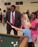 Mayor Brown playing bumper pool with summer camp participants
