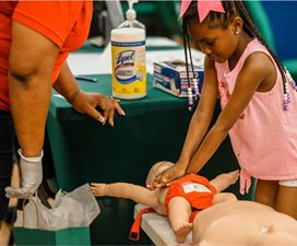 child practicing CPR