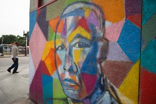 colorful mural of a man on side of building