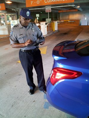 A parking enforcement officer issuing a citation